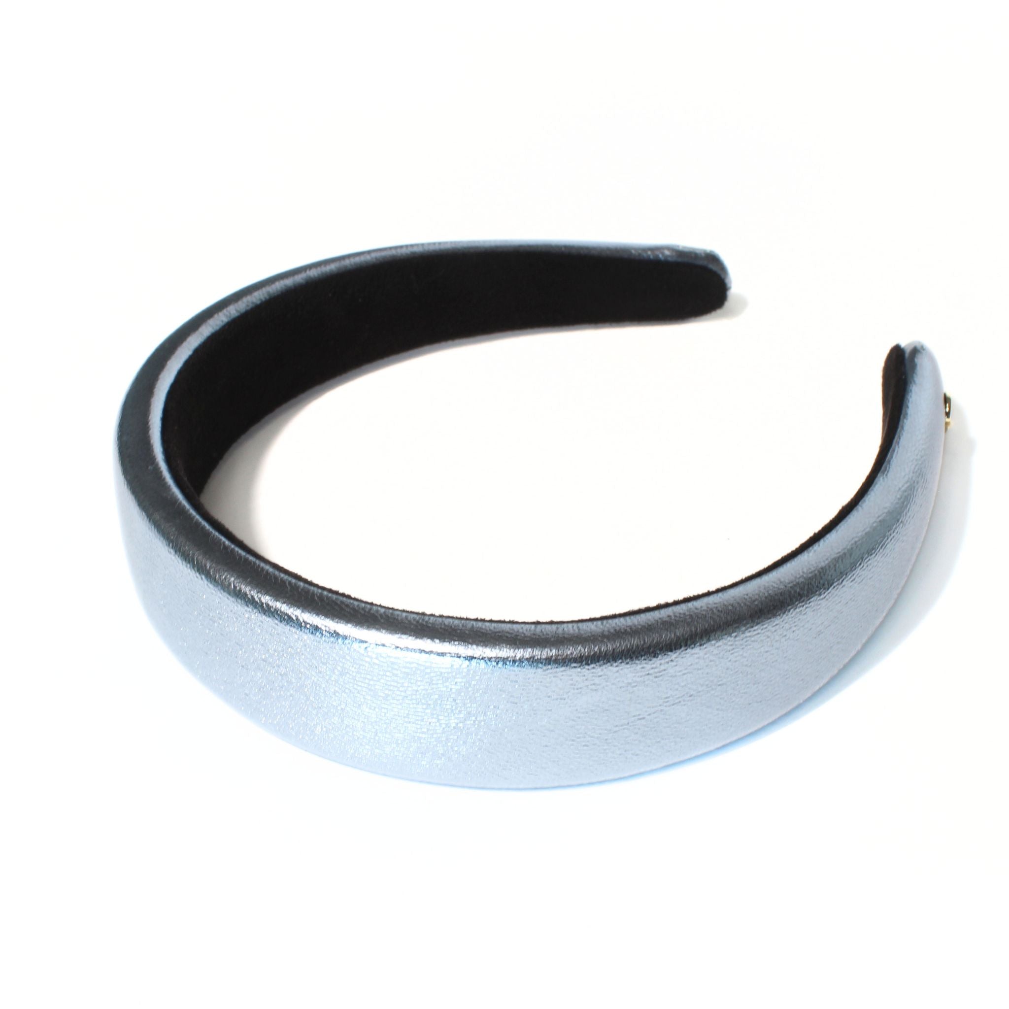 Blue leather headband made from faux leather, featuring a padded design for a stylish and comfortable fit.