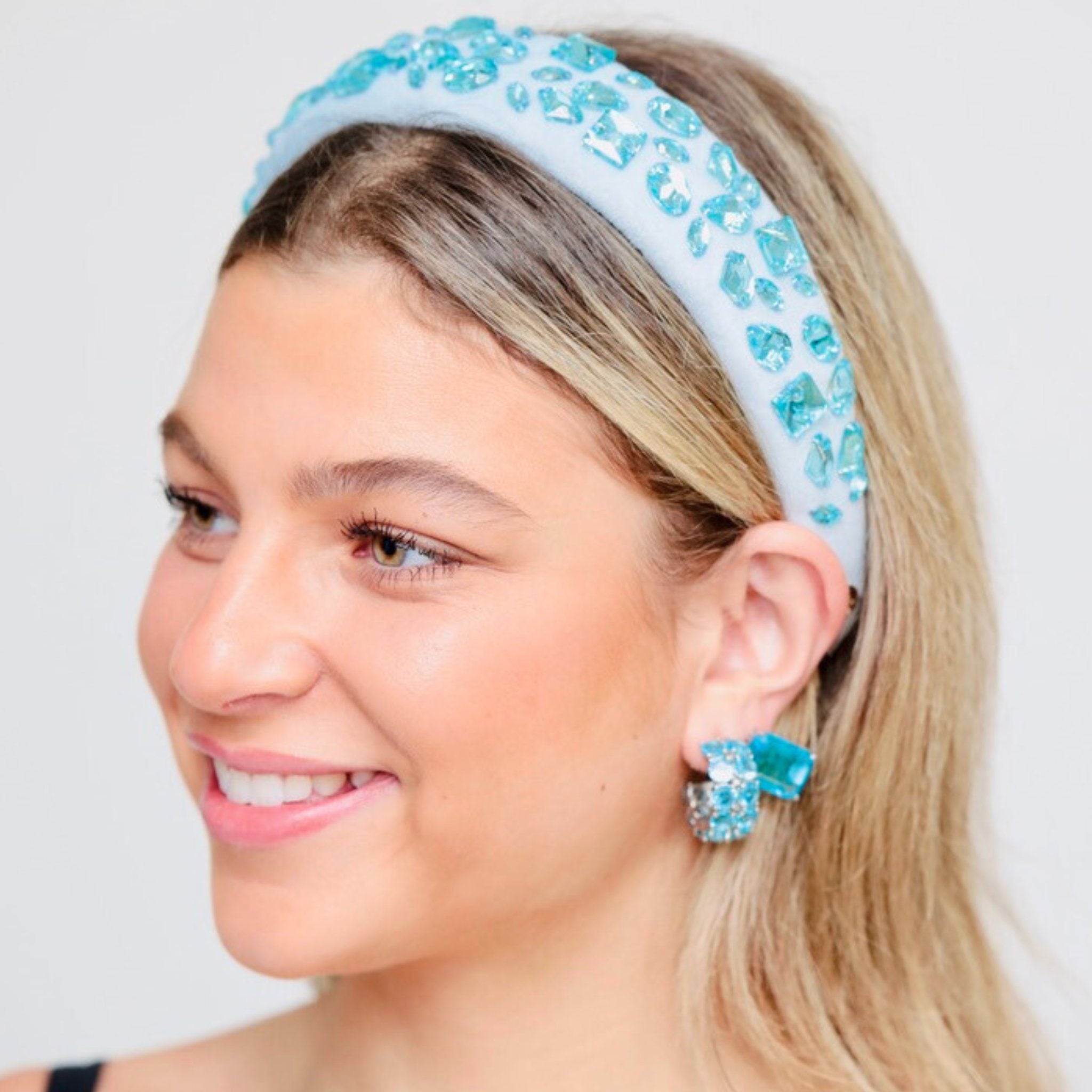 Blue head band shown styled on a model, offering a comfortable, secure fit for all-day wear