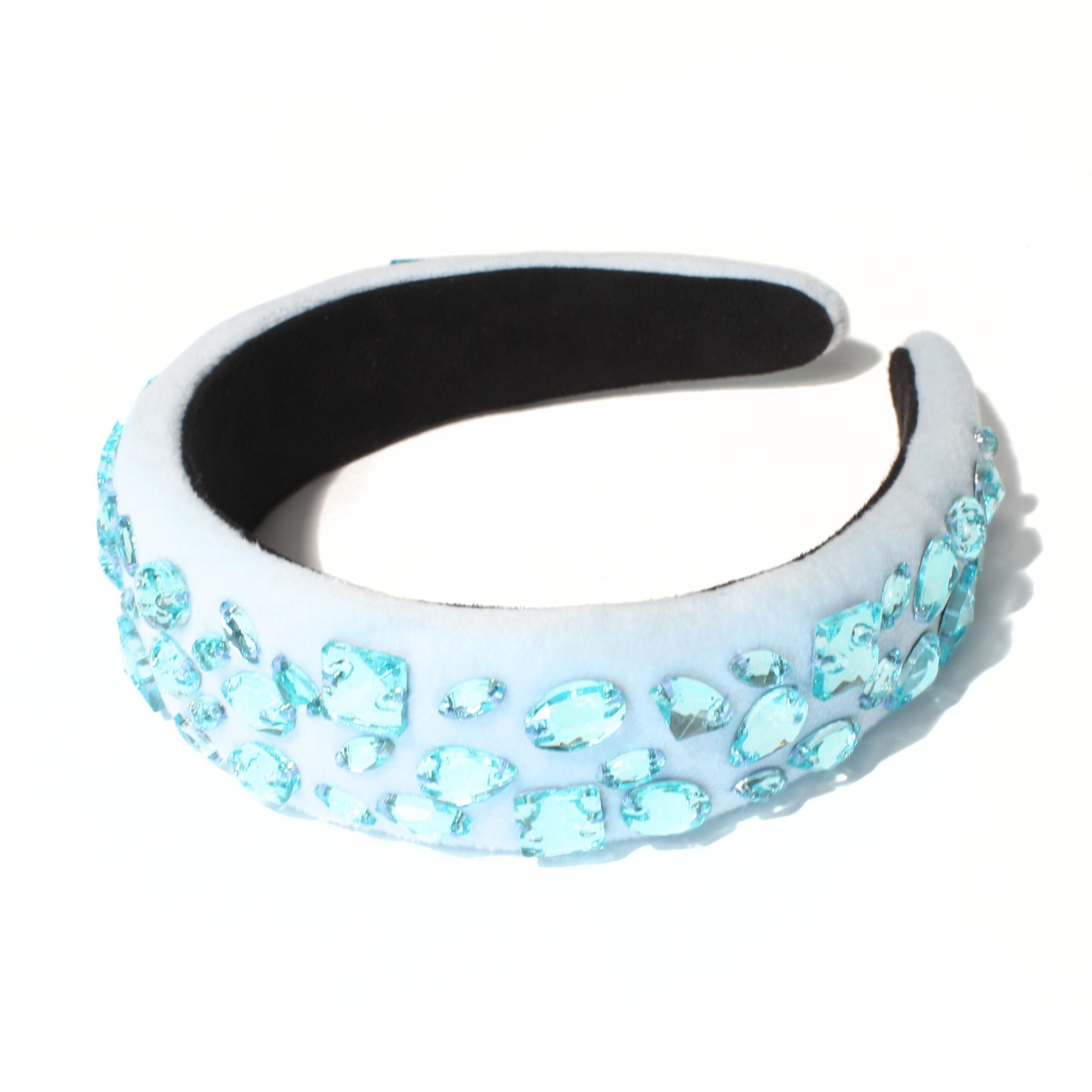 Light blue headband with sparkling crystal detail, catching the light for a polished finish