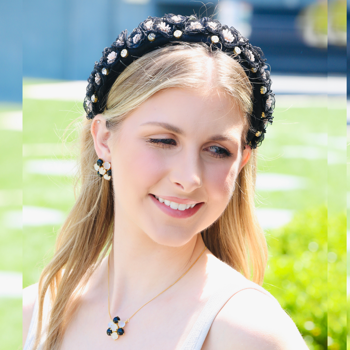 A black flower headband, the silk blooms clustered off to one side rather than spread evenly.