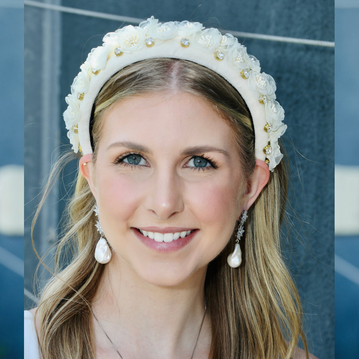 A tiara headband for a wedding, silk florals raised along a white velvet band.