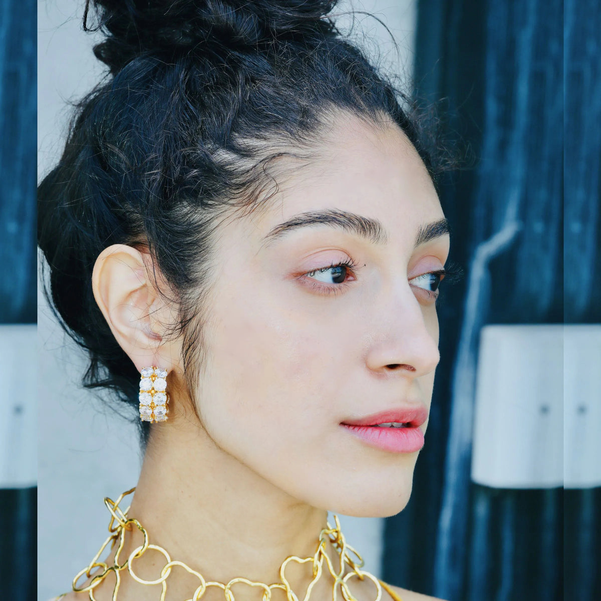 Close-up of sparkly hoop earrings showing two rows of prong-set crystals
