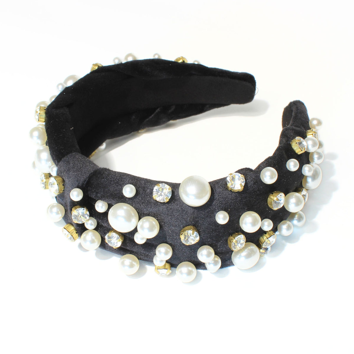 Black knot headband adorned with shimmering rhinestones and pearls on a velvet fabric