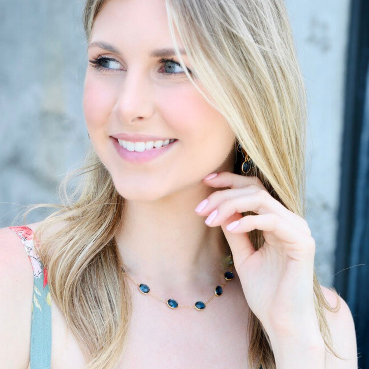 One of our blue crystal necklaces designed to build a layered necklace set, whether stacked high or worn as a simple gold chain necklace alone.