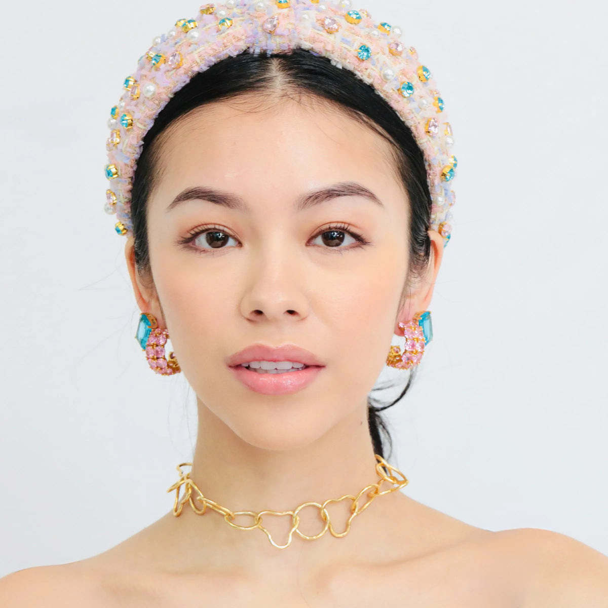 Pink hoop earrings worn on the ear