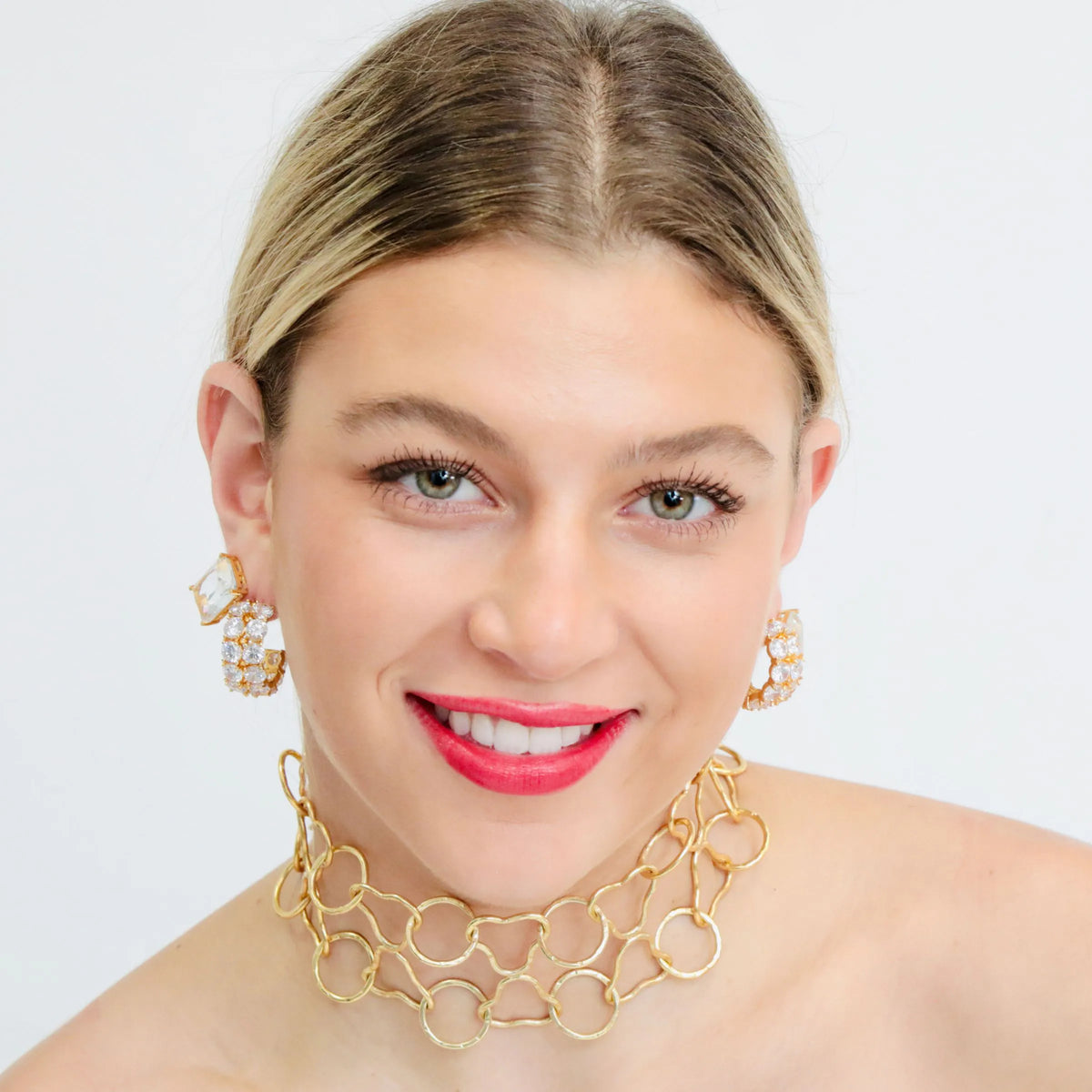 Gold and crystal hoop earrings with clear diamond-cut stones