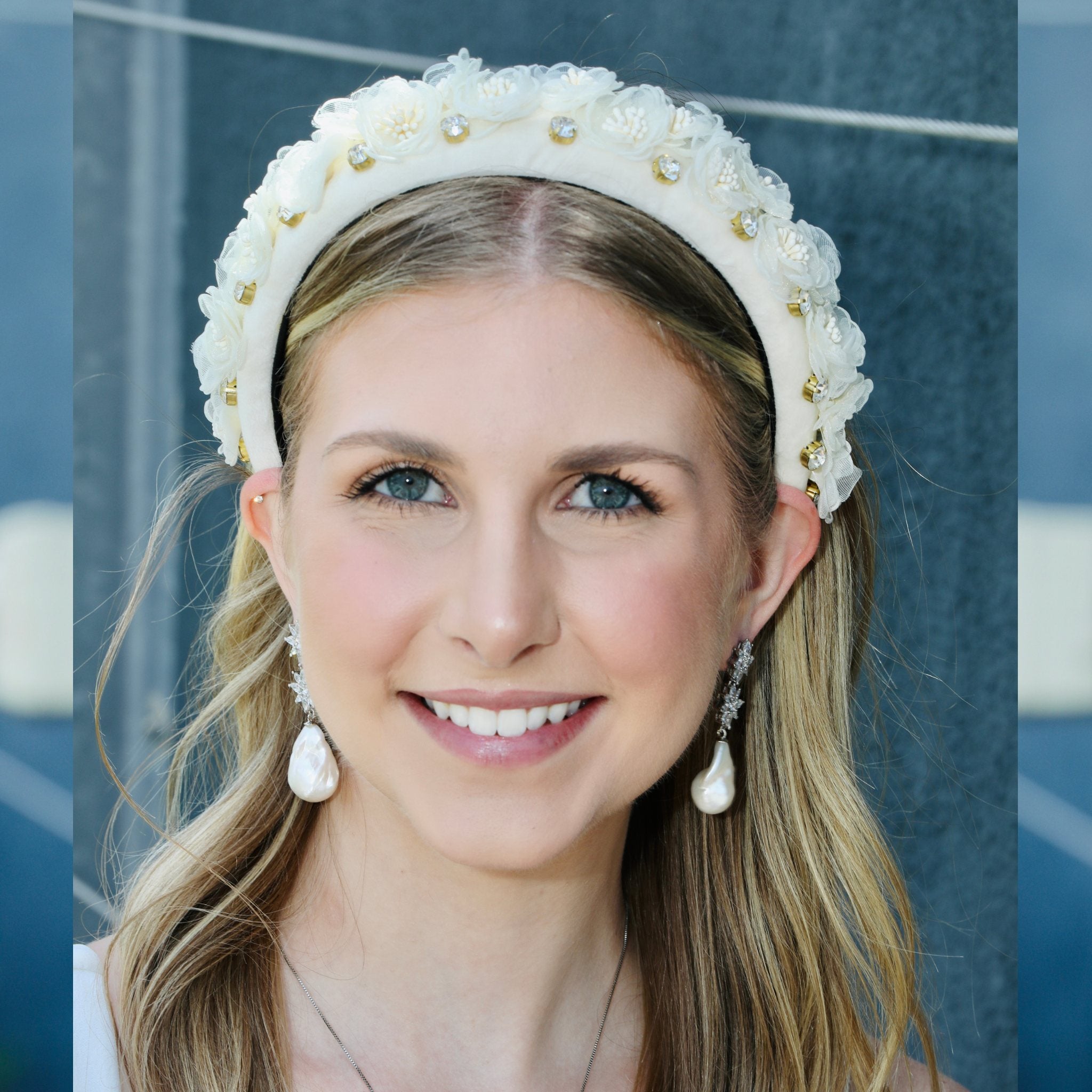 A tiara headband for a wedding, silk florals raised along a white velvet band.
