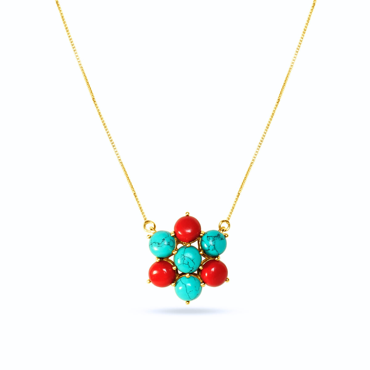 This red floral necklace pairs vivid cabochon stones with a sleek gold chain for a bold pop of color.
