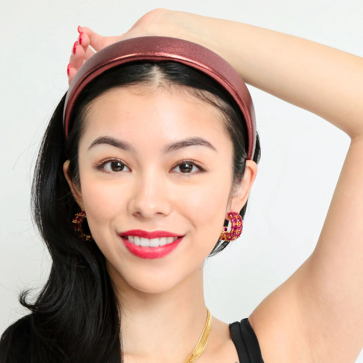 Close-up of ruby drop earrings showing the faceted stones