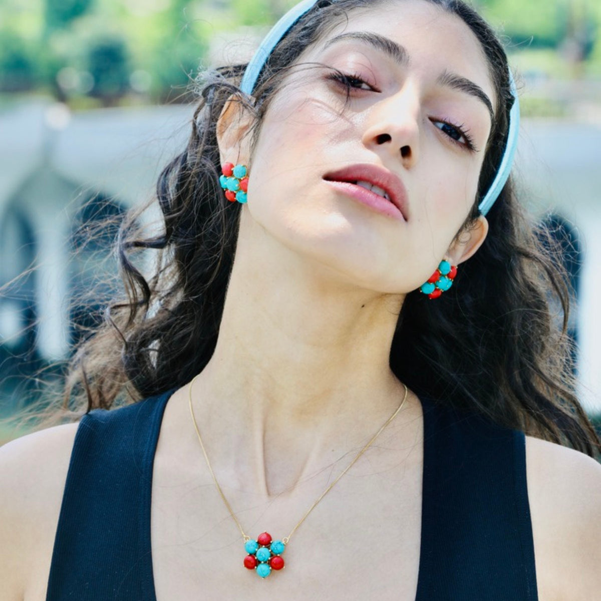 A closer look at the turquoise cabochon detailing on this flower pendant necklace, designed by u-glam.