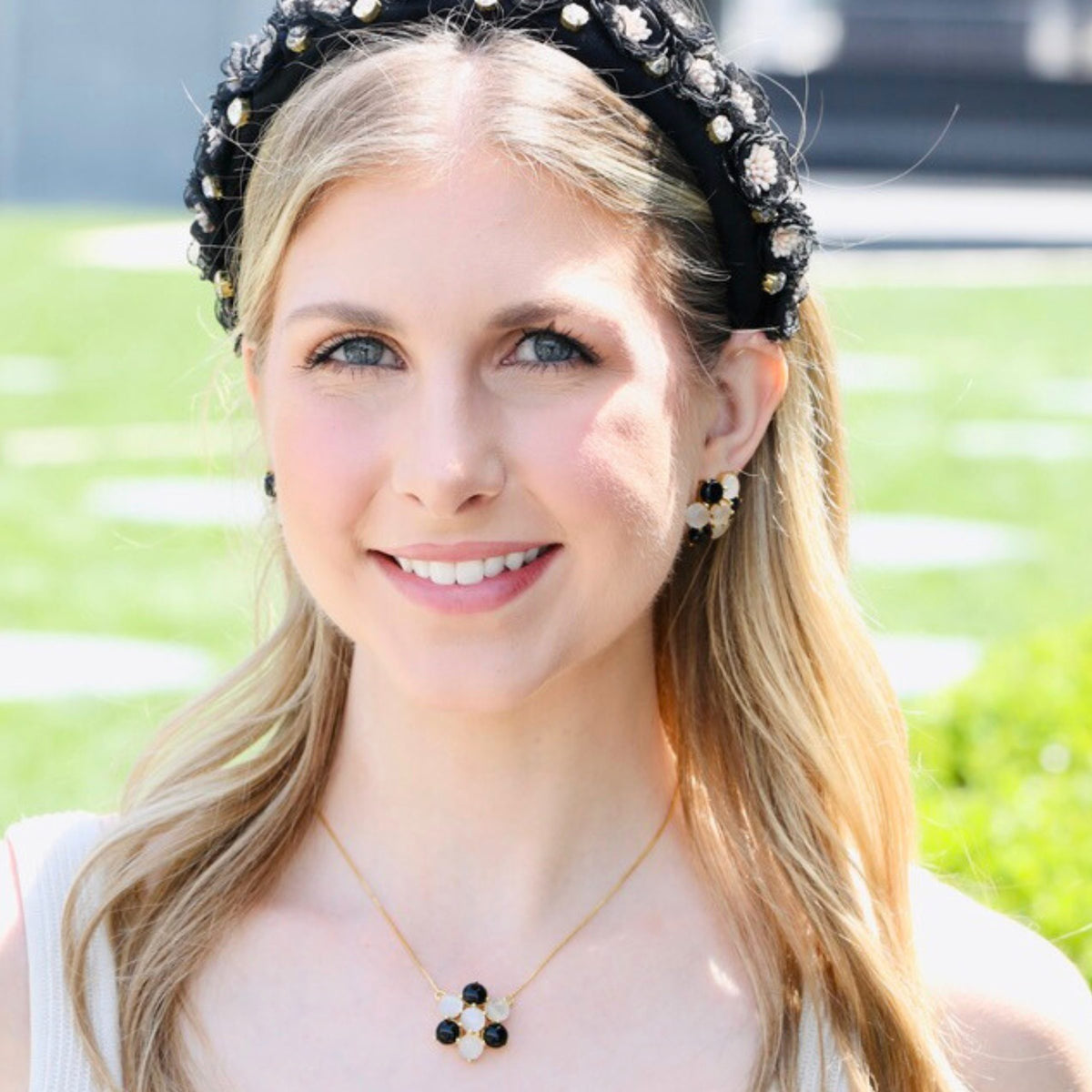 A closer look at the ivory and black petals on this flower pendant necklace, designed by u-glam.