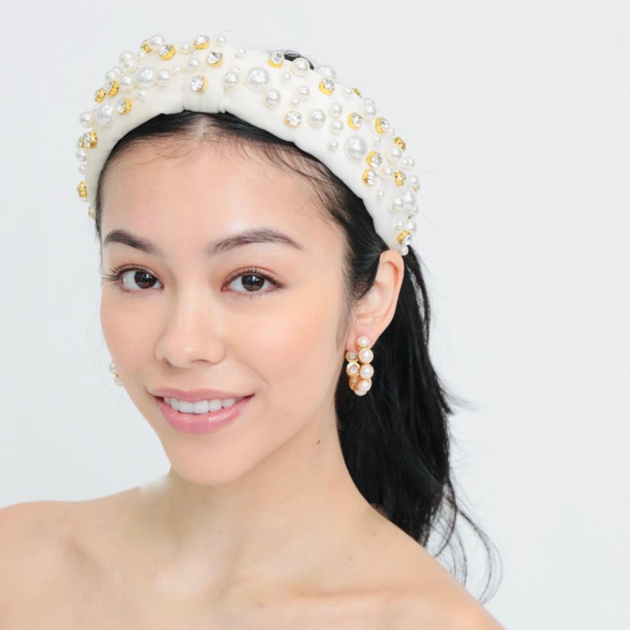beaded headband featuring a sophisticated knot design adorned with pearl and rhinestone embellishment, perfect for brides and special occasions.